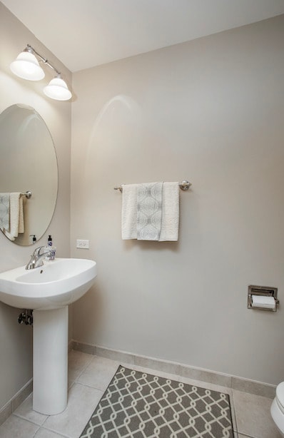 bathroom with toilet and tile patterned floors