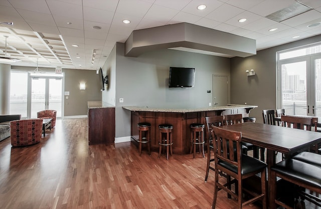 dining area with french doors, hardwood / wood-style floors, and a wealth of natural light