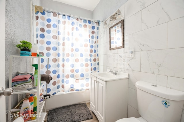 full bathroom featuring tile walls, vanity, shower / bath combination with curtain, and toilet