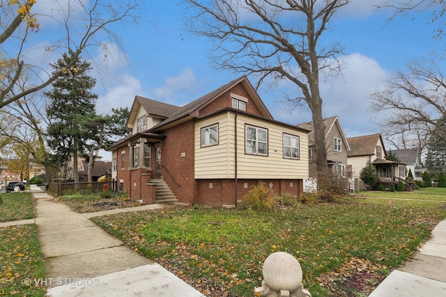 view of property exterior featuring brick siding and a yard