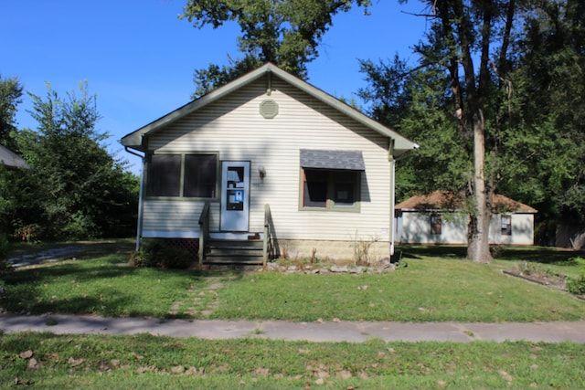 bungalow-style home with a front yard