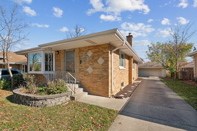 view of front of house featuring a garage and an outdoor structure