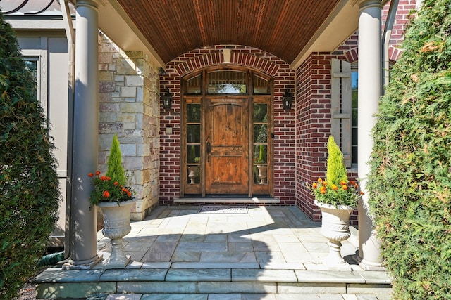 view of exterior entry with a porch