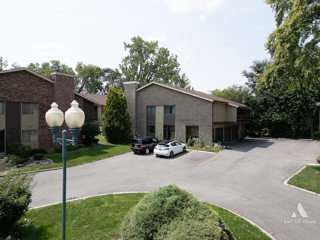 exterior space with a front lawn and a balcony