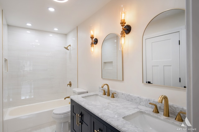 full bathroom with toilet, tiled shower / bath combo, and vanity