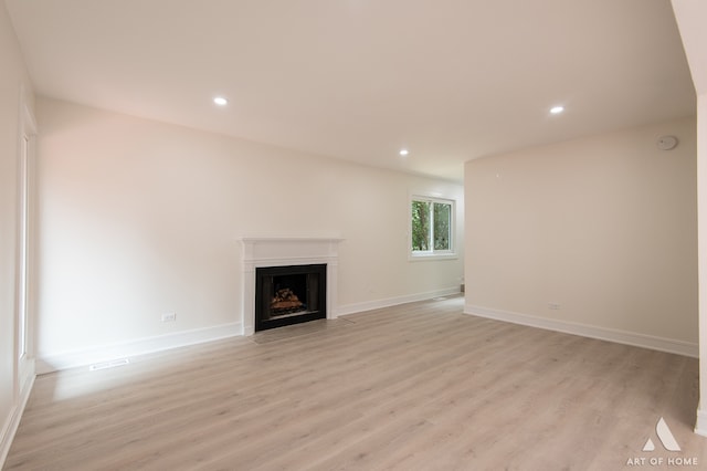 unfurnished living room with light hardwood / wood-style flooring