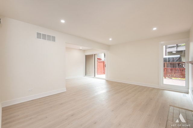 empty room featuring plenty of natural light and light hardwood / wood-style floors