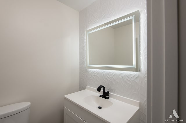 bathroom featuring toilet and vanity