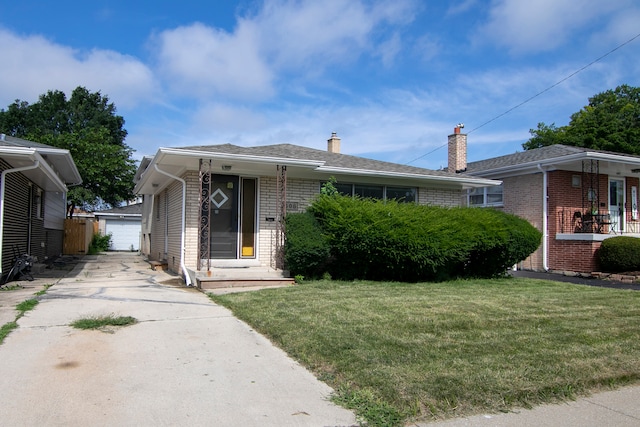 view of front of house with a garage and a front lawn