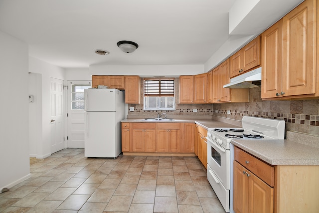 kitchen featuring sink, backsplash, light tile patterned flooring, and white appliances