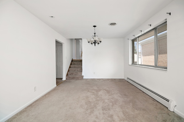 carpeted spare room with baseboard heating and a chandelier