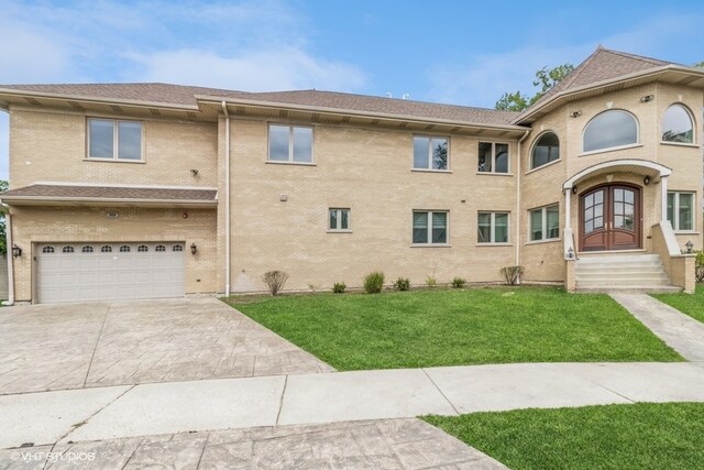 view of front of home with a front yard and a garage