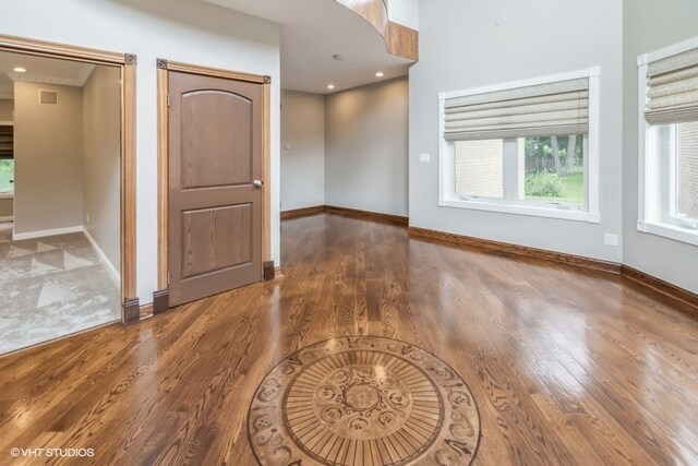 unfurnished room with hardwood / wood-style flooring