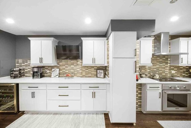 680 N Lake Shore Dr Unit 519, Chicago, IL 60611 - kitchen with beverage cooler, light countertops, wall chimney exhaust hood, black electric cooktop, and stainless steel oven
