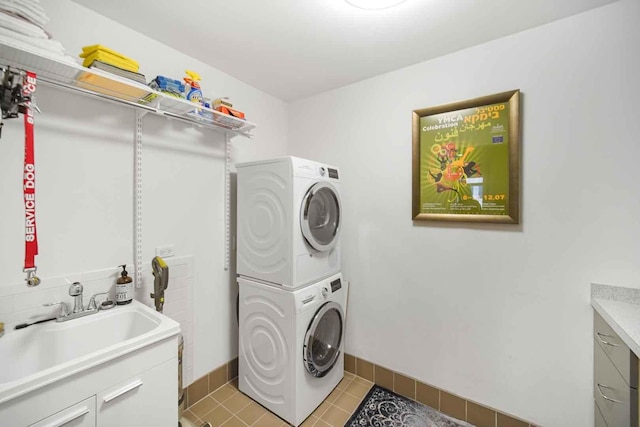 680 N Lake Shore Dr Unit 519, Chicago, IL 60611 - laundry room with stacked washing maching and dryer, light tile patterned floors, baseboards, and a sink