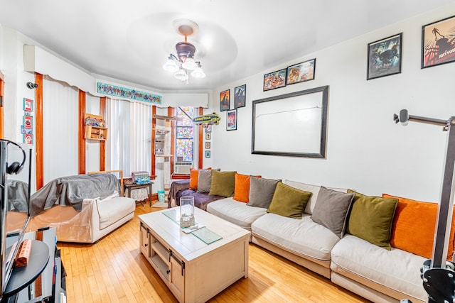 living room featuring cooling unit, light hardwood / wood-style flooring, and ceiling fan