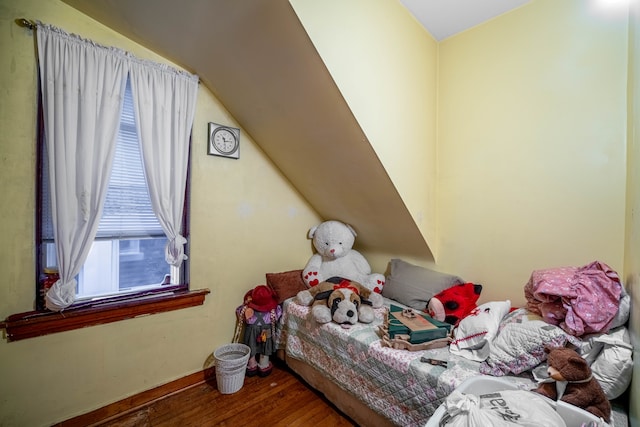 bedroom with dark hardwood / wood-style floors