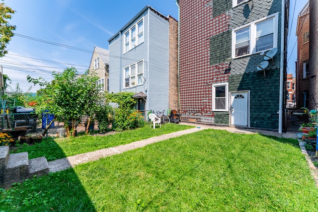 rear view of property with a lawn