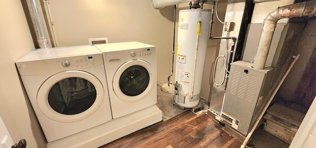 laundry room with laundry area, dark wood-style flooring, gas water heater, and washing machine and dryer