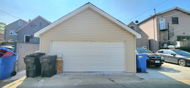 detached garage featuring fence