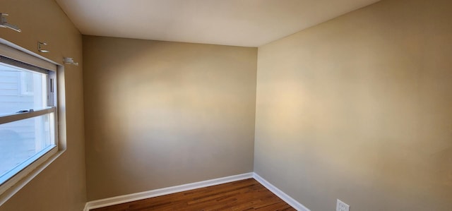 empty room with baseboards and wood finished floors