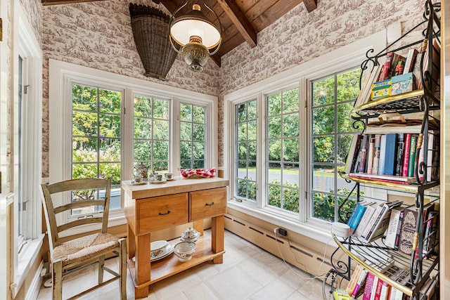 sunroom / solarium featuring a baseboard radiator, lofted ceiling with beams, and a healthy amount of sunlight