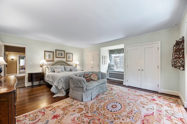 bedroom with crown molding, radiator, and hardwood / wood-style flooring