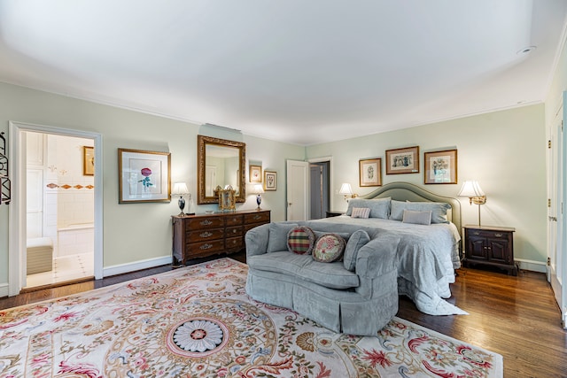 bedroom with wood-type flooring, connected bathroom, and crown molding