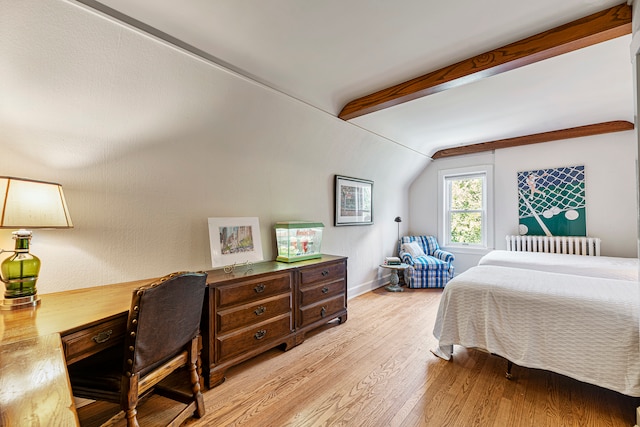 bedroom with radiator heating unit, lofted ceiling with beams, and light hardwood / wood-style floors