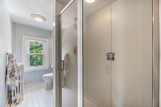 bathroom with walk in shower, toilet, and tile patterned flooring