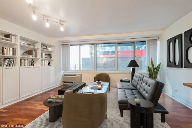 living room featuring dark hardwood / wood-style flooring and an AC wall unit