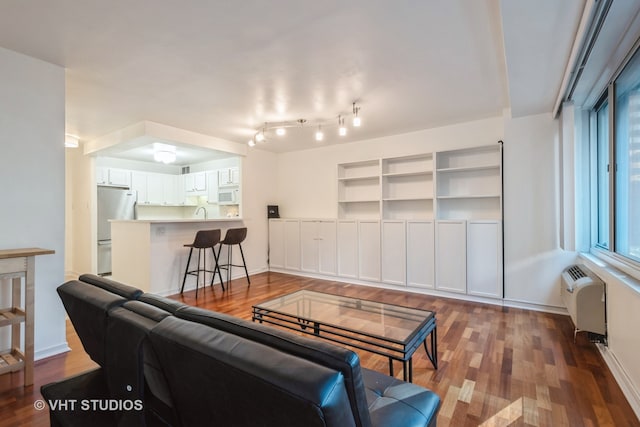 living room with radiator and hardwood / wood-style floors