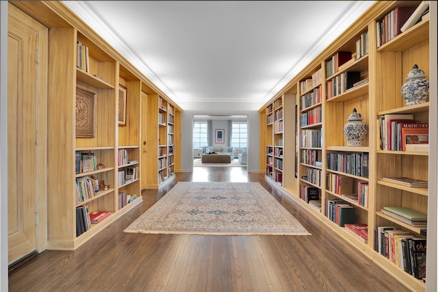 sitting room with built in features, ornamental molding, and hardwood / wood-style floors