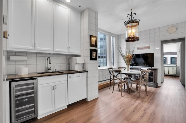 kitchen with white dishwasher, wine cooler, sink, and light hardwood / wood-style floors