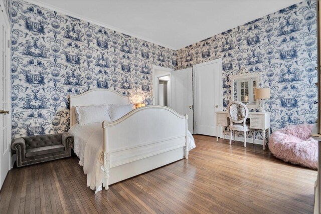 bedroom featuring crown molding and hardwood / wood-style flooring