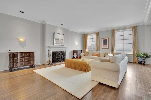 living room with ornamental molding and hardwood / wood-style flooring