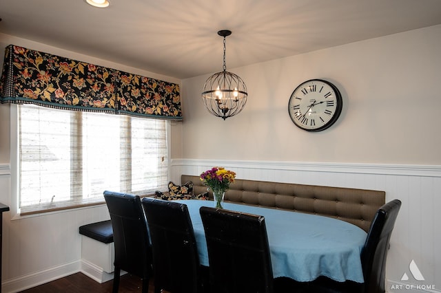 dining space with an inviting chandelier and dark hardwood / wood-style flooring