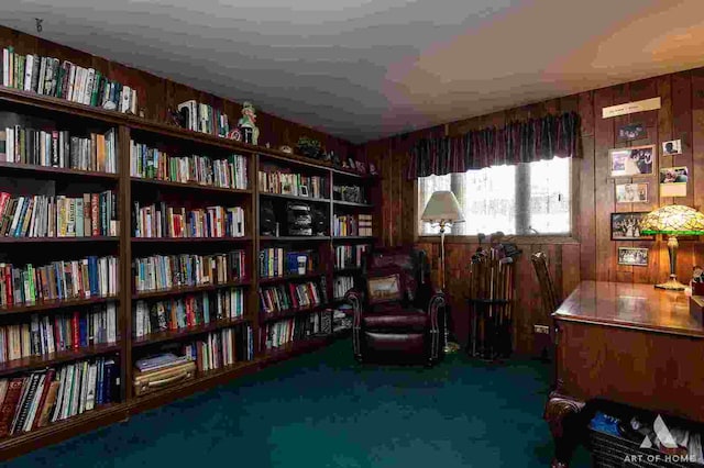 living area featuring carpet floors and wood walls