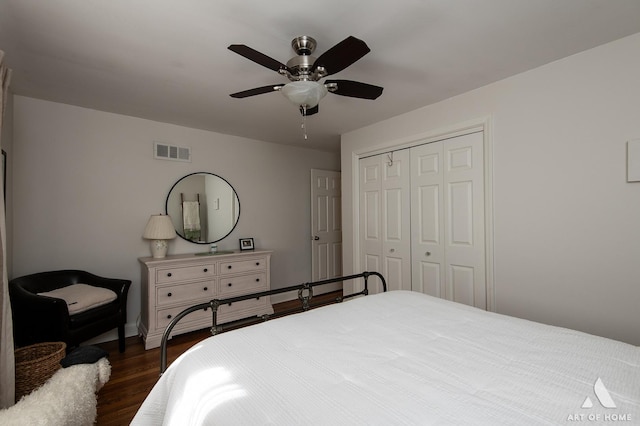 bedroom with dark wood-type flooring, a closet, and ceiling fan