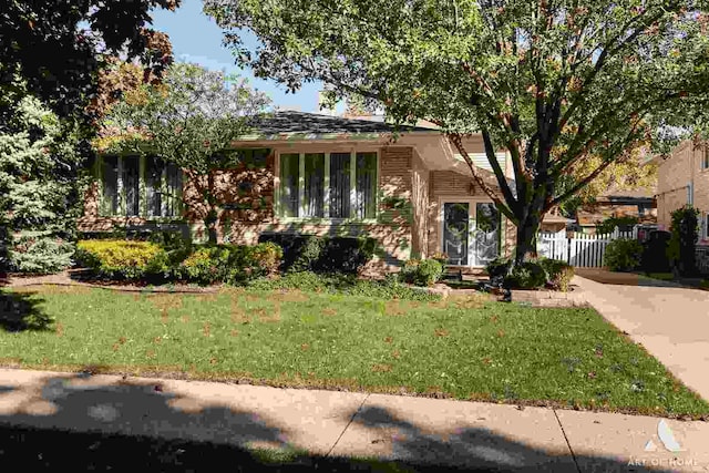 tri-level home with a front yard