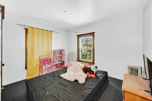 bedroom with radiator heating unit and carpet floors