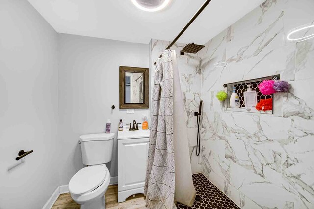 bathroom with vanity, walk in shower, toilet, and hardwood / wood-style flooring