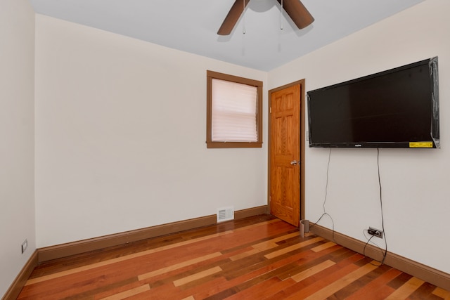 unfurnished room featuring hardwood / wood-style floors and ceiling fan