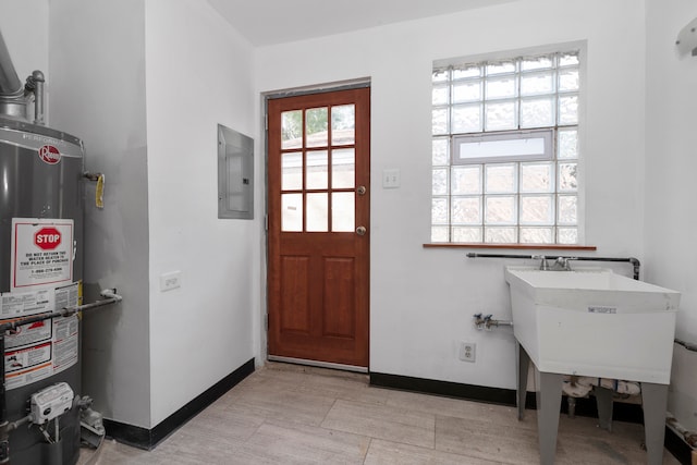 interior space featuring electric panel, sink, and water heater