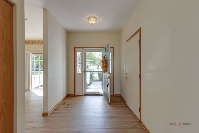 entryway featuring baseboards and light wood-style floors