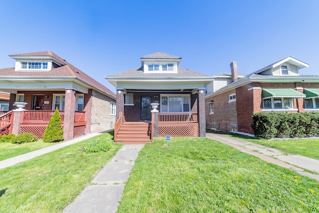 view of front of house featuring a front yard and covered porch