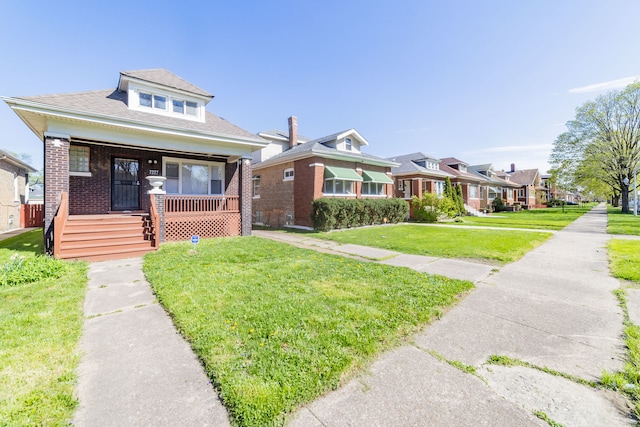 bungalow-style home with covered porch and a front lawn