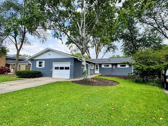 ranch-style home featuring a front lawn and a garage