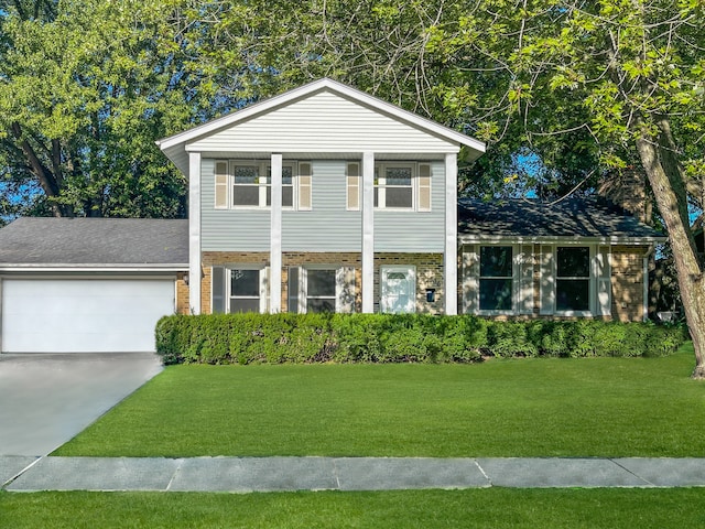 view of front of property with a garage and a front lawn