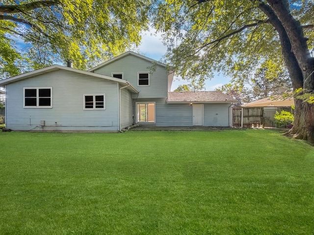 back of house with a lawn